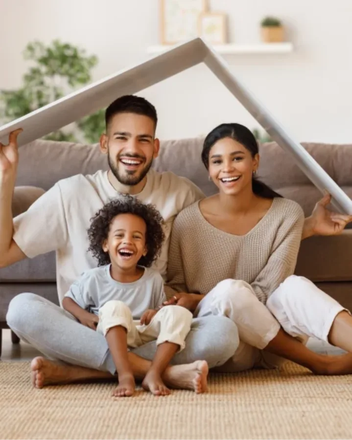 Happy young family standing in front of their new Las Vegas home
